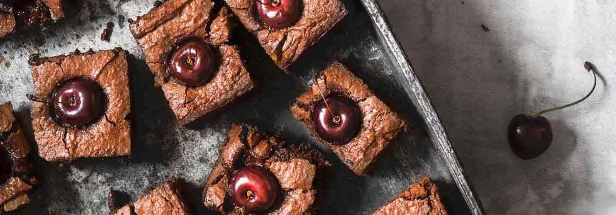 Cherry-Chocolate Cake Kirsch-Schokoladen Kuchen Es gibt Kuchen und es gibt „DIE“ Kuchen. DIE Kuchen sind voller Schokolade und innen noch ganz saftig. Ich kann dann kaum erwarten diese in Stücke zu schneiden und Menschen (also die, die ich kenne) in den Mund zu stecken. Denn ich weiß ganz genau was passiert: noch während sie kauen, verdrehen sie leicht die Augen und ein „WOW“ ertönt. Ich mag das. Natürlich kannst du auch Kirschen ohne Kerne nehmen, aber für das Foto sahen die Kirschen mit Stil einfach schöner aus. 1 Form ca. 20 x 20 cm 100 g Butter 400 g Vollmilchschokolade 4 Eier 150 g Zucker 1 Prise Salz 200 g gemahlene Mandeln 2 EL Kirschwasser 6 EL Mehl ca. 20 Kirschen Butter und Schokolade über einem Wasserbad langsam schmelzen lassen Eier mit Zucker und Salz schaumig aufschlagen Schokoladenmasse, Mandeln, Kirschwasser und Mehl zugeben und verrühren Backofen auf 200 Grad Ober-Unterhitze vorheizen und eien Springform mit Backpapier auslegen Teig in die Form geben und glatt streichen Die Kirschen in den Teig drücken Teig im Ofen 25 -30 Minuten backen (falls der Kuchen zu dunkel wird, mit Alufolie abdecken), herausnehmen und vollständig abkühlen lassen