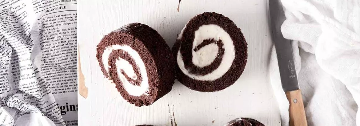 Schoko-Bananen-Rolle Chocolate Banana Roll Ich könnte jeden Tag eine Biskuitrolle machen. Sie ist so schnell gemacht und einfach unglaublich vielfältig. Ich mag sie am liebsten, wenn der Teig ganz dünn ist und ganz viel Creme eingerollt wurde. Fluffiger Schokoteig und innen einen süße Bananen-Mascarponecreme. 5 Eier 1 Prise Salz 160 g Zucker 100 g Mehl 30 g Backkakao 30 g Speisestärke 1 EL Backpulver Bananencreme 400 ml Bananensaft 80 g Zucker 40 g Speisestärke 200 g Mascarpone Für die Füllung Bananensaft und Zucker aufkochen lassen. 4 EL davon abnehmen und mit der Speisestärke verrühren. Stärke in den Topf gießen und unter Rühren kurz aufkochen lassen, danach vollständig auskühlen lassen. Mascarpone unterrühren und bis zur Verwendung zur Seite stellen. Backofen auf 180 Grad Ober-Unterhitze vorheizen und ein Backblech mit Backpapier auslegen. Eier trennen und Eiweiße mit dem Salz steif schlagen. Zum Ende hin 110 g Zucker einrieseln lassen und weiterschlagen bis sich der Zucker vollständig aufgelöst hat. Eigelbe unterrühren. Mehl, Stärke, Backkakao und Backpulver vermengen und unter die Eiermasse heben. unterheben Teig auf das Backpapier verstreichen und im Ofen 15 Minuten backen Ein Küchenhandtuch (ich mache es immer leicht feucht) ausbreiten und mit restlichem Zucker bestreuen. Biskuit aus dem Ofen nehmen und sofort auf das Küchenhandtuch stürzen und mithilfe des Küchentuchs, von der langen Seite her aufrollen und auskühlen lassen. Biskuit vorsichtig entrollen, Creme darauf verteilen und (ohne Küchenhandtuch) wieder aufrollen. Mindestens 2 Stunden kaltstellen.