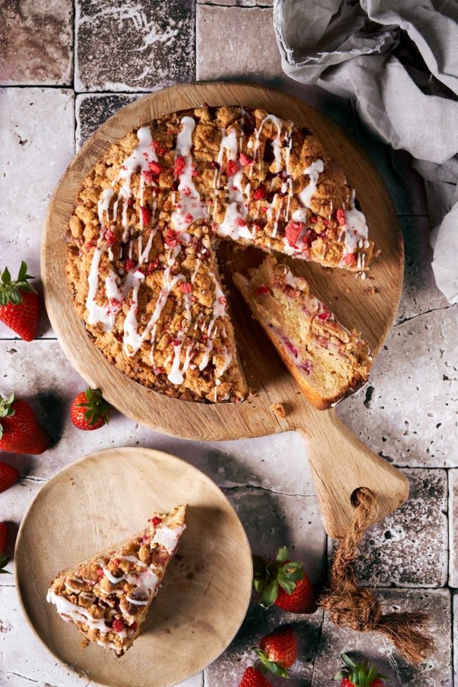 Erdbeer Streuselkuchen auf einem Tisch mit Puderzuckerglasur